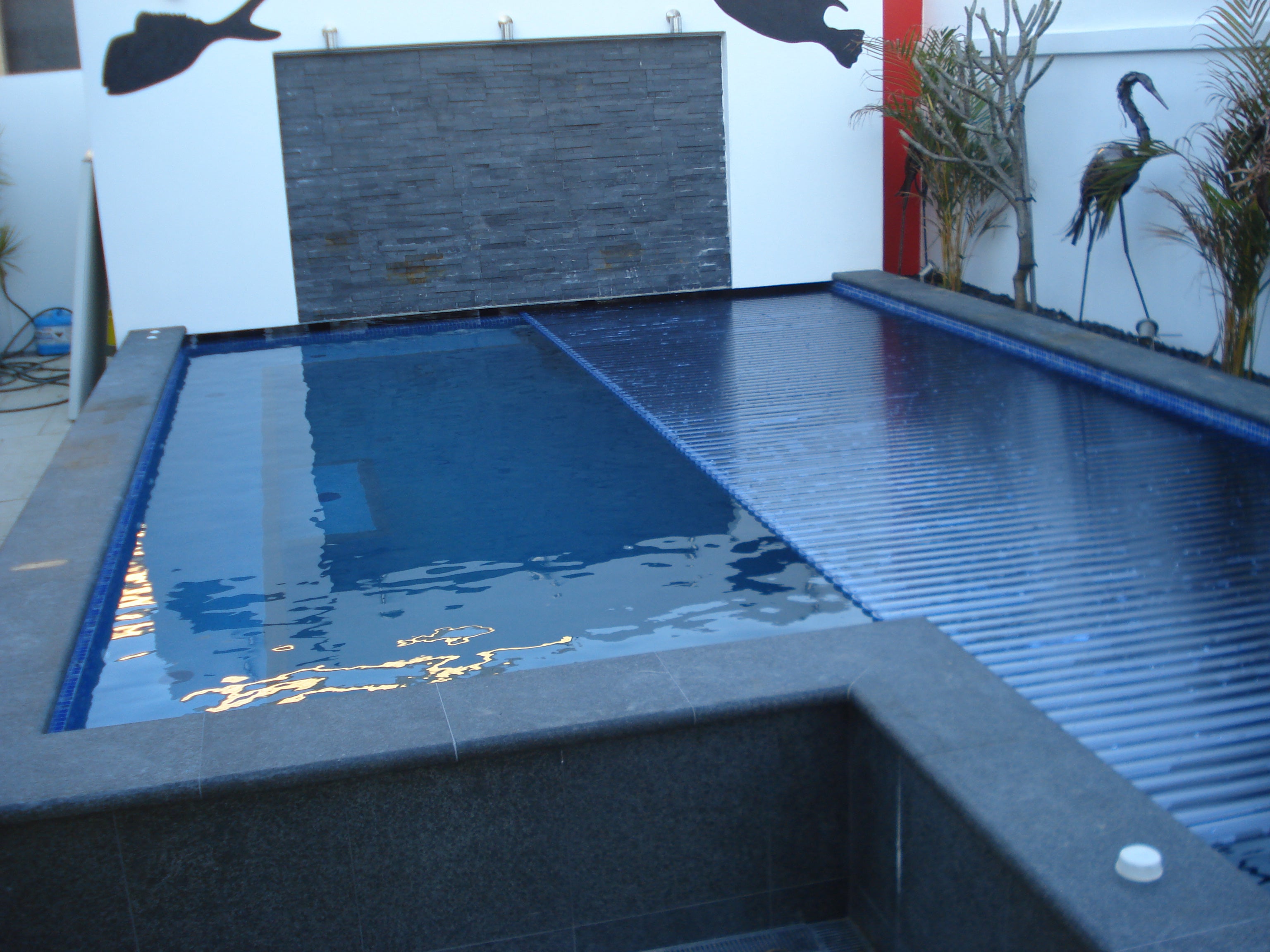 Aquaroll Rigid Slat automated pool cover on a pool