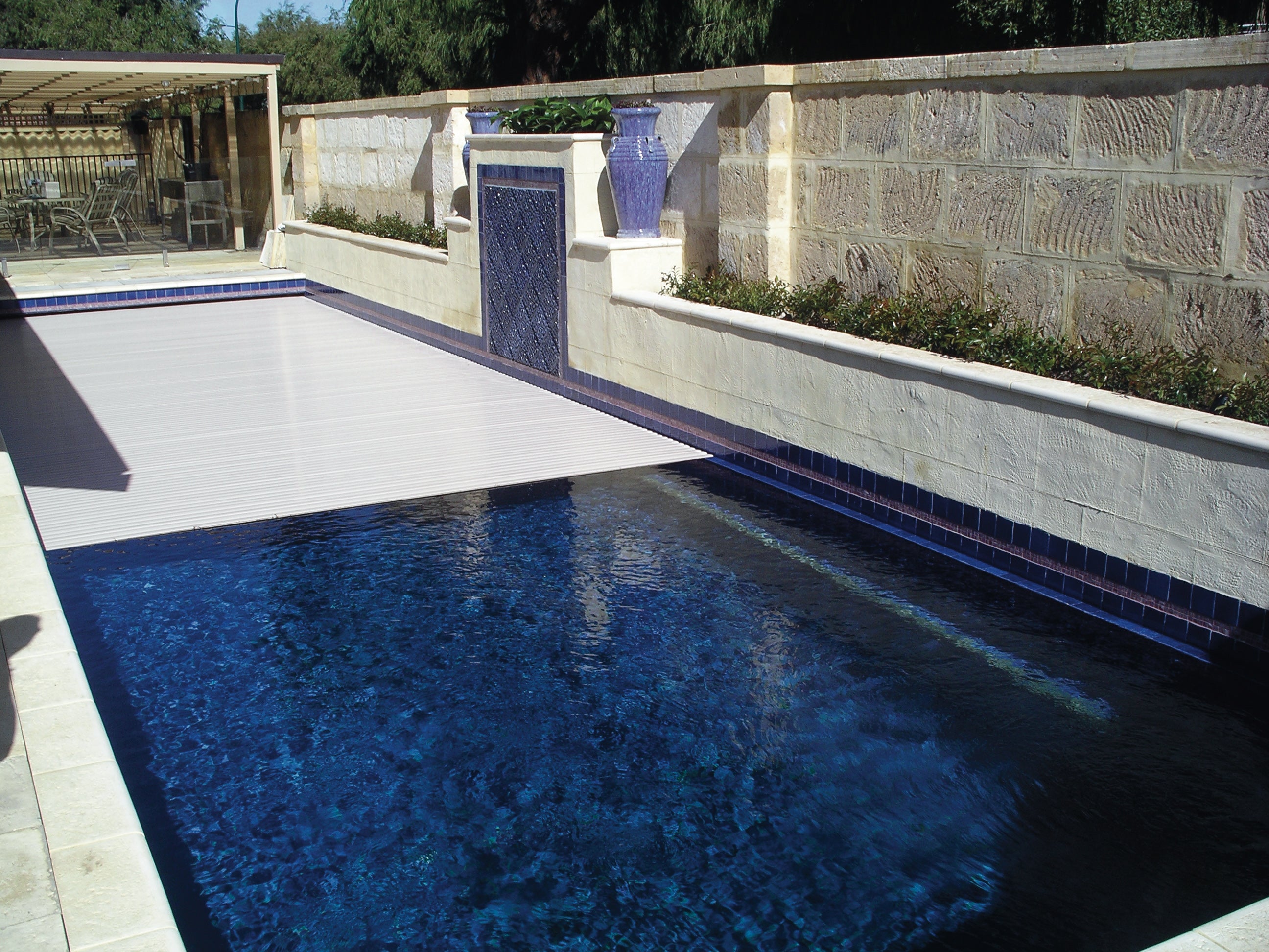 Aquaroll Rigid Slat automated pool cover on a pool