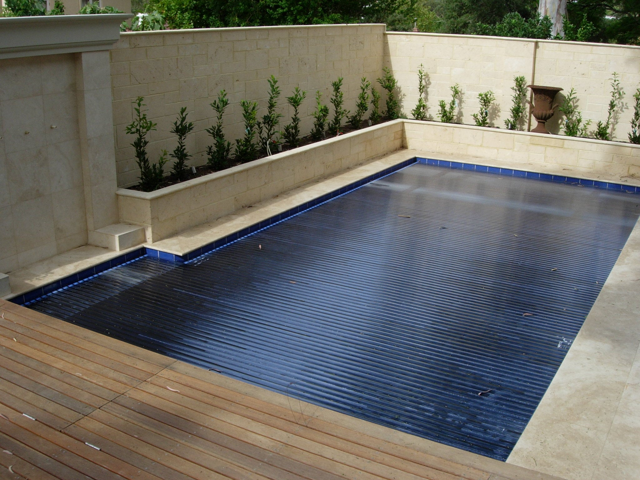 Aquaroll Rigid Slat automated pool cover on a pool