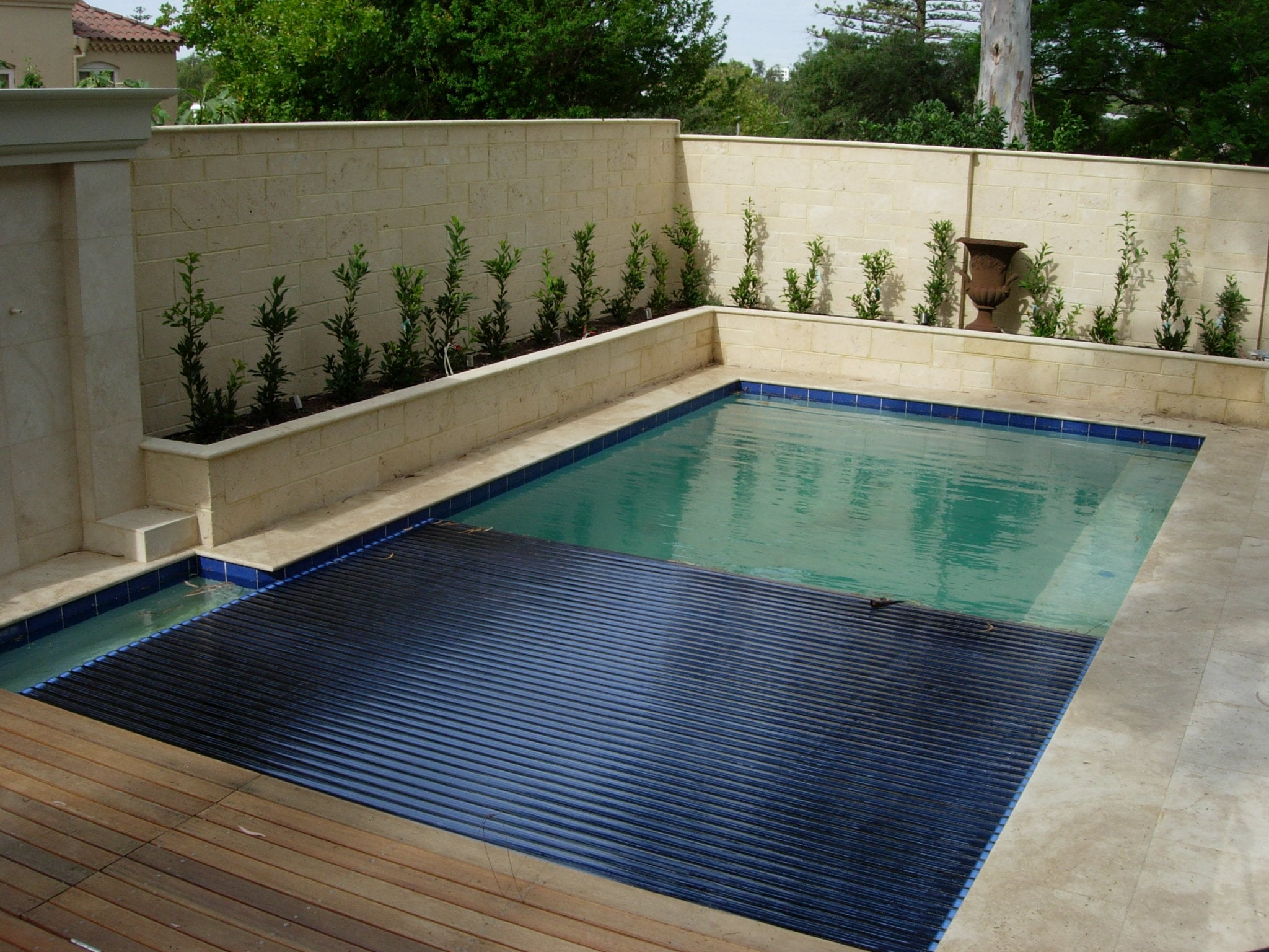 Aquaroll Rigid Slat automated pool cover on a pool