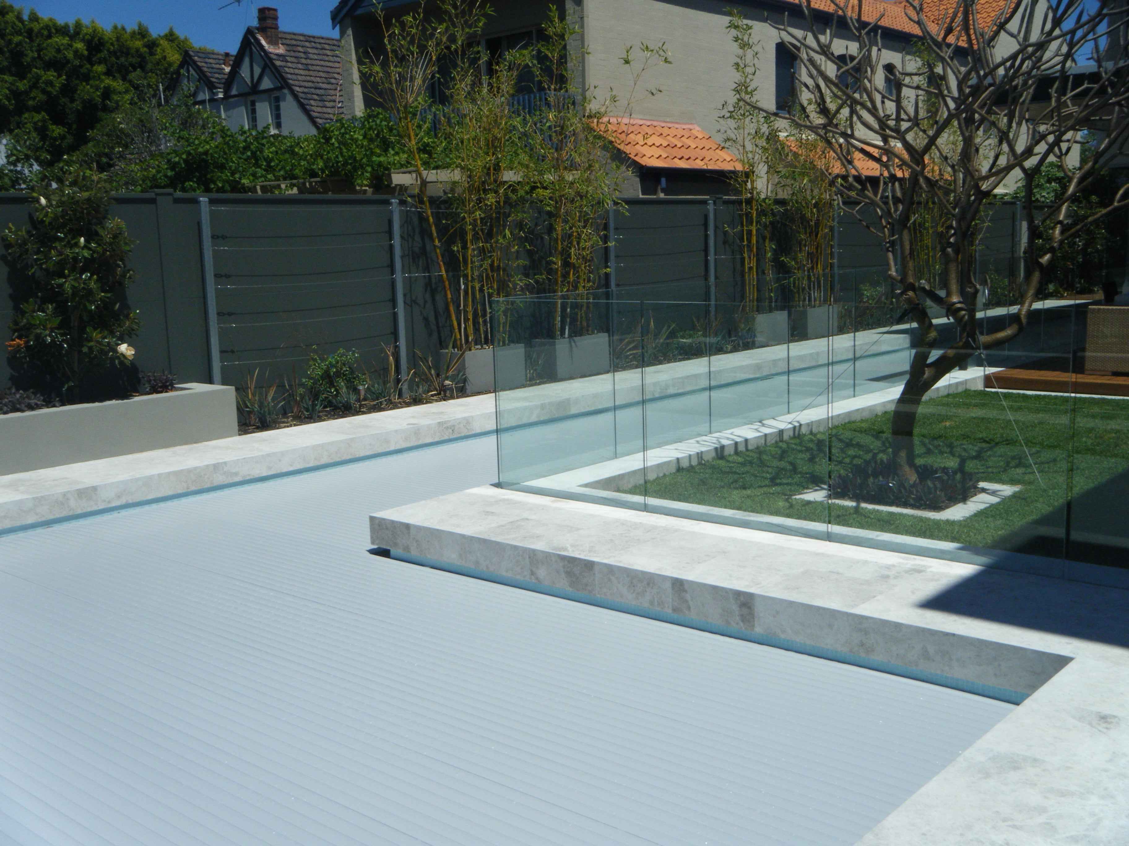 Aquaroll Rigid Slat automated pool cover on a pool